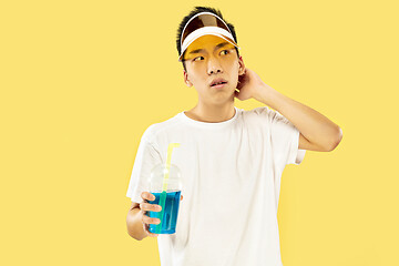 Image showing Korean young man\'s half-length portrait on yellow background