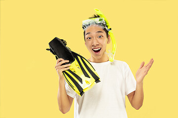 Image showing Korean young man\'s half-length portrait on yellow background