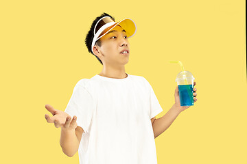 Image showing Korean young man\'s half-length portrait on yellow background