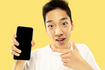 Image showing Korean young man\'s half-length portrait on yellow background