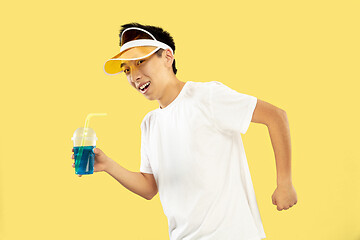 Image showing Korean young man\'s half-length portrait on yellow background