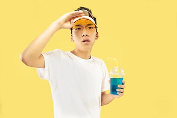 Image showing Korean young man\'s half-length portrait on yellow background