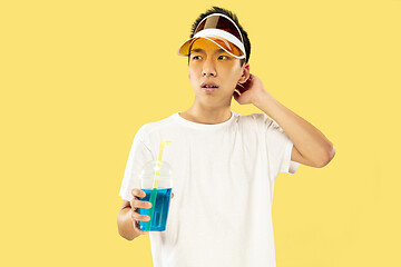 Image showing Korean young man\'s half-length portrait on yellow background