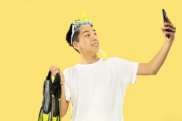 Image showing Korean young man\'s half-length portrait on yellow background