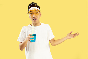 Image showing Korean young man\'s half-length portrait on yellow background