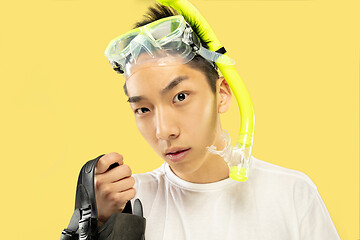 Image showing Korean young man\'s half-length portrait on yellow background