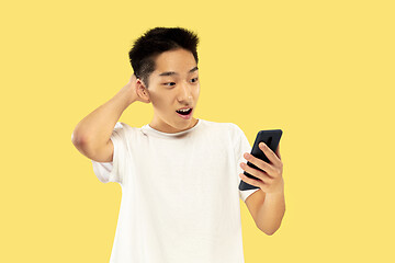 Image showing Korean young man\'s half-length portrait on yellow background