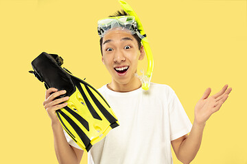 Image showing Korean young man\'s half-length portrait on yellow background