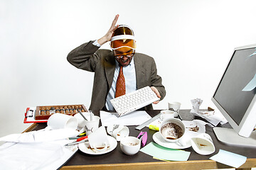 Image showing Young man spilled coffee on the keyboard