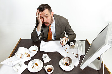 Image showing Young man drinking a lot of coffee