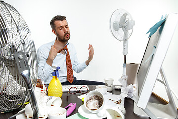 Image showing Young man ssuffering from the heat in the office