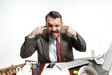 Image showing Young man suffering from the talks in the office