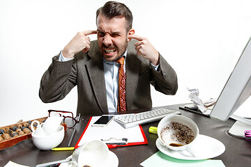 Image showing Young man suffering from the talks in the office