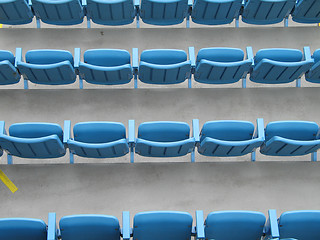 Image showing blue aligned plastic chairs