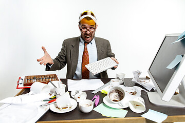 Image showing Young man spilled coffee on the keyboard