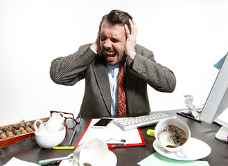 Image showing Young man suffering from the talks in the office