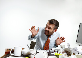 Image showing Young man suffering from the noise in the office