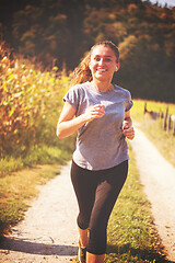 Image showing woman jogging along a country road