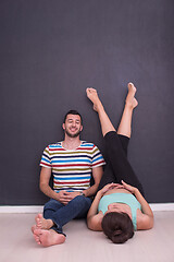 Image showing pregnant couple relaxing on the floor