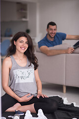 Image showing pregnant couple checking a list of things for their unborn baby