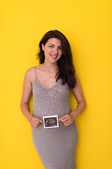 Image showing pregnant woman showing ultrasound picture