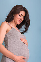 Image showing Portrait of pregnant woman over blue background