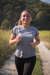 Image showing woman jogging along a country road