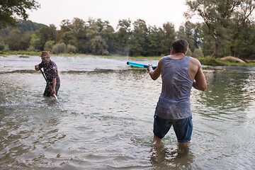 Image showing young men having fun with water guns