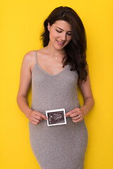 Image showing pregnant woman showing ultrasound picture