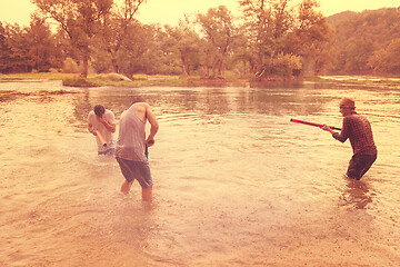 Image showing young men having fun with water guns