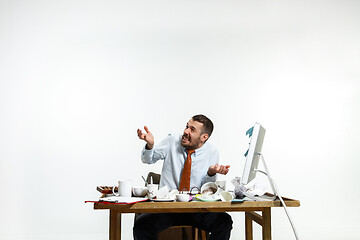 Image showing Young man suffering from the noise in the office