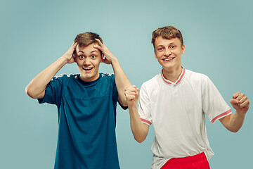 Image showing Two young men isolated on blue background