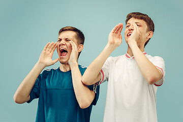 Image showing Two young men isolated on blue background