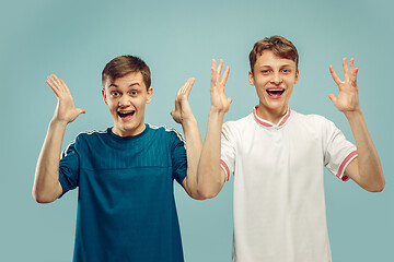 Image showing Two young men isolated on blue background