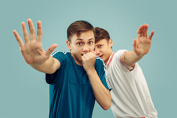 Image showing Two young men isolated on blue background