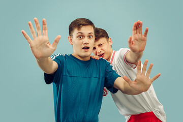 Image showing Two young men isolated on blue background