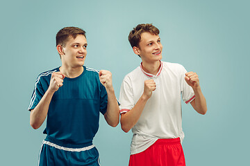 Image showing Two young men isolated on blue background