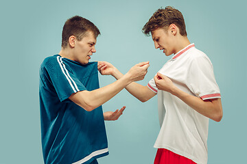 Image showing Two young men isolated on blue background