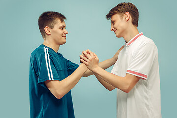 Image showing Two young men isolated on blue background