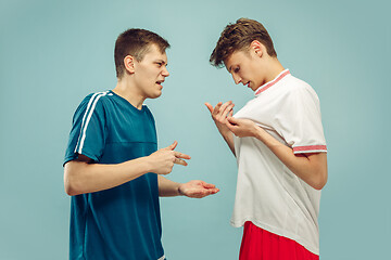 Image showing Two young men isolated on blue background