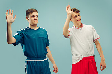 Image showing Two young men isolated on blue background