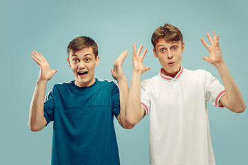 Image showing Two young men isolated on blue background