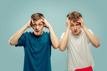 Image showing Two young men isolated on blue background