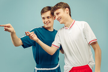 Image showing Two young men isolated on blue background