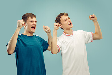 Image showing Two young men isolated on blue background