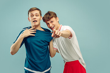 Image showing Two young men isolated on blue background