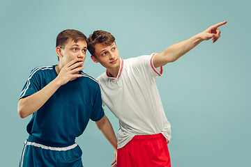 Image showing Two young men isolated on blue background