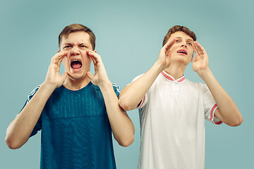 Image showing Two young men isolated on blue background