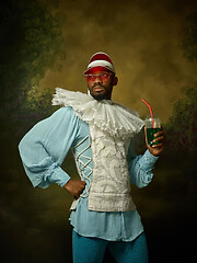 Image showing Young man as a medieval knight on dark background