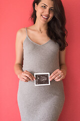 Image showing happy pregnant woman showing ultrasound picture